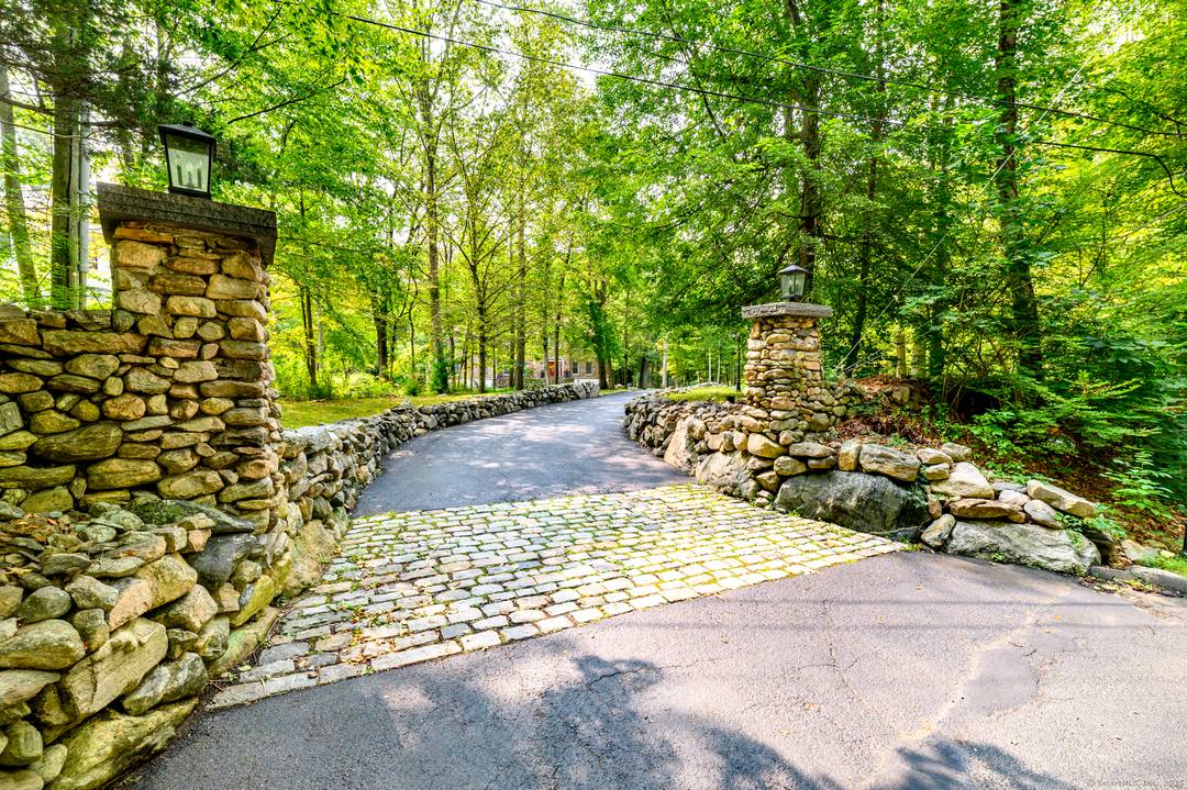 Set back from the road and set on two level acres, this stately all brick colonial feels private yet perfectly connected to everyday conveniences.