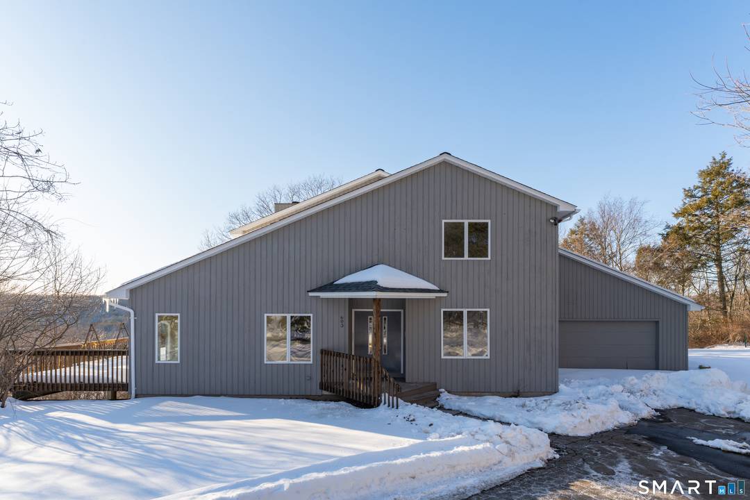 Perched atop a scenic hill on four acres, this 4 bed, 3 full bath home with nearly 3, 000 sq ft of living space overlooks the majestic Lake Quonnipaug.