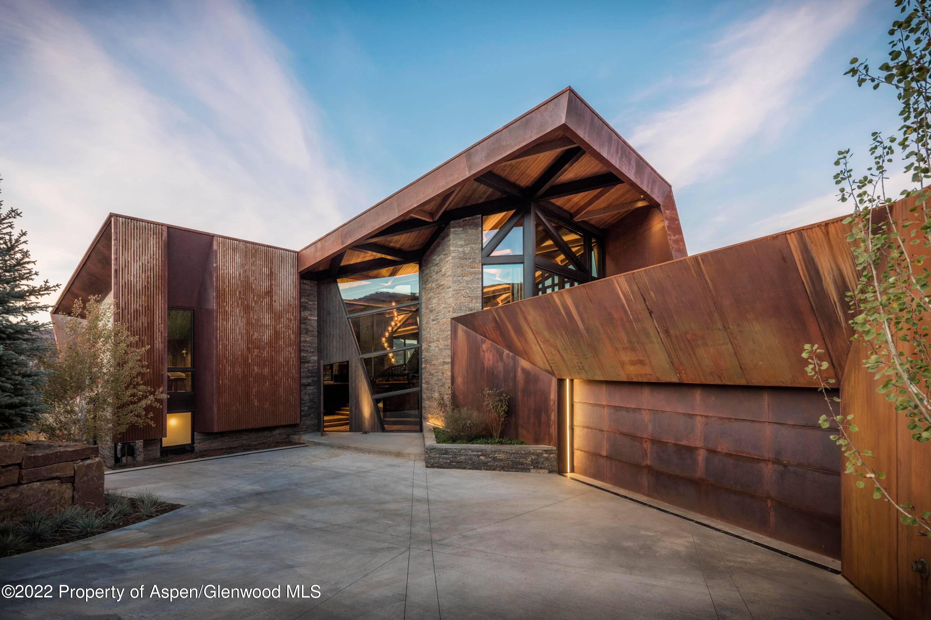 This home is a truly iconic modern ski lodge, perched on a hill with the most incredible mountain views from every room.