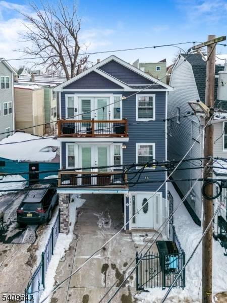 Beautiful newer construction three family home with modern curb appeal and parking.