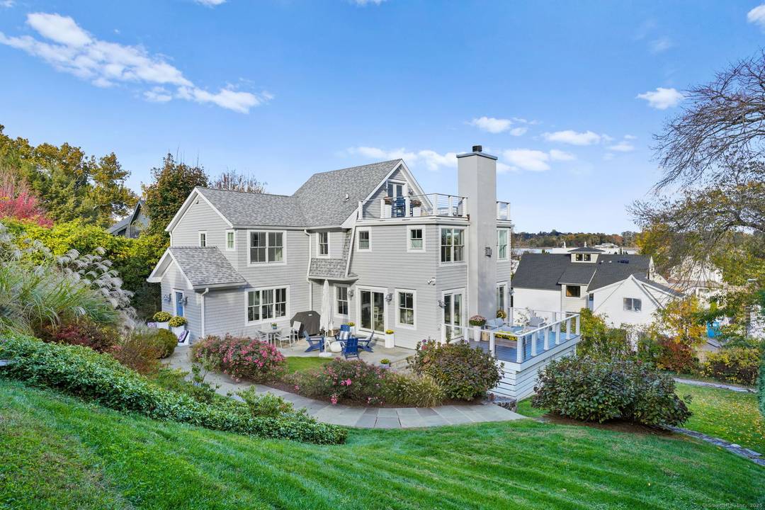 Nestled in privacy by nearly 100 arborvitaes, this ultimate retreat on a rare double lot is just steps from Old Mill Beach Compo Beach.