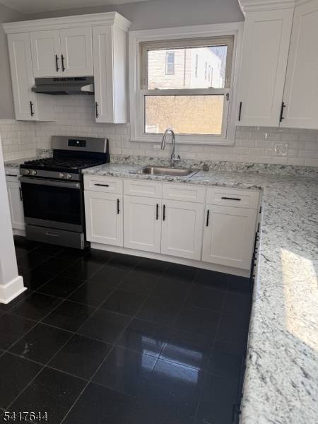 Beautiful wood floors, granite tile kitchen floor with sleek white kitchen cabinets, spacious unfinished basement, and large backyard.