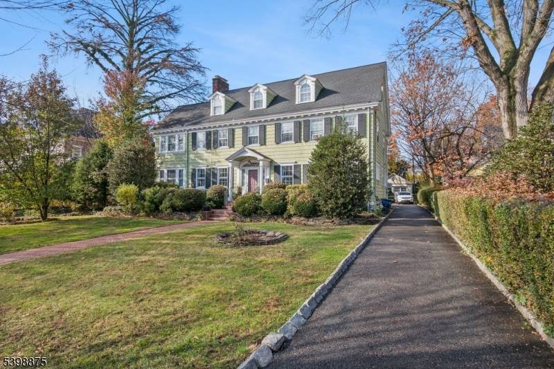 Step into timeless elegance in this classic center hall Colonial, brimming with stunning architectural detail and ideally situated just 1 2 blocks from the train station and local shops.