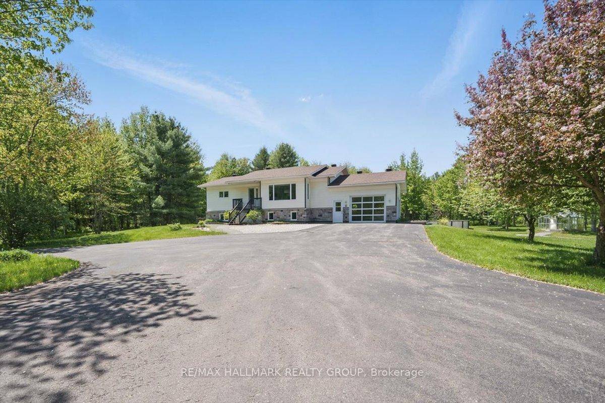 Nestled on almost 25 sprawling acres, this recently renovated raised bungalow offers unparalleled privacy and tranquility.