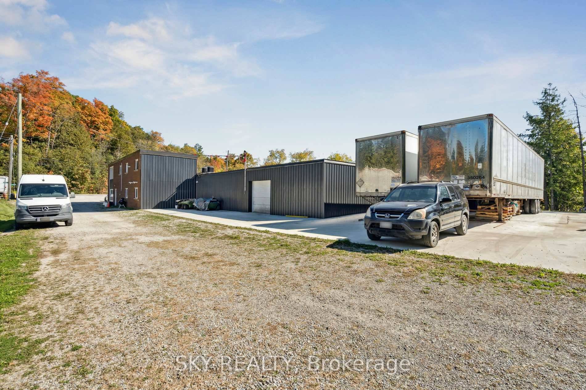 Unique 1 acre property featuring a freestanding 9000 sq ft Commercial industrial Building with an updated 3 bedroom house and 2 bedroom apartment above warehouse.