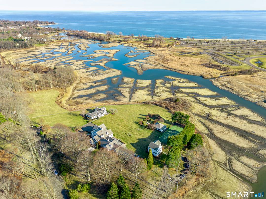 Hidden along a private lane in Westport's Greens Farms neighborhood, this extraordinary 20 acre waterfront estate unfolds as one of the most remarkable shoreline settings ever offered.