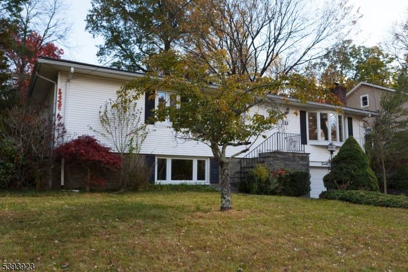 Enjoy easy living in this bright and sunny ranch home featuring a cozy stone fireplace, spacious dining area, and a large deck perfect for relaxing, entertaining, and gardening.