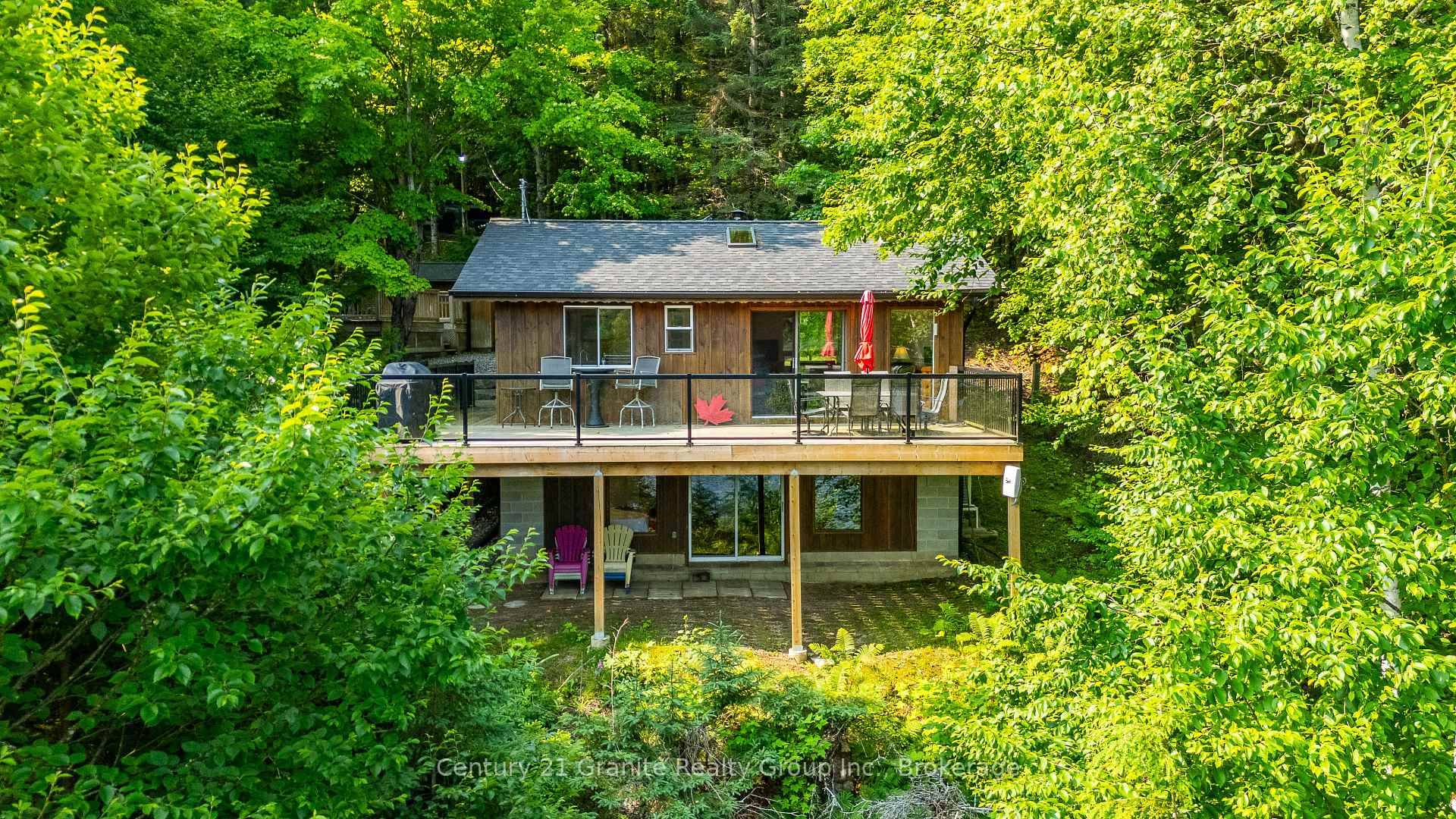 Beautiful Four season cottage set on a sloping tiered lot with over 100 feet of pristine shoreline on Esson Lake.