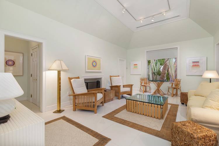 Tucked away in the heart of Palm Beach, this quintessential island bungalow is a rare jewelbox, offering privacy, charm, and effortless indoor outdoor living.