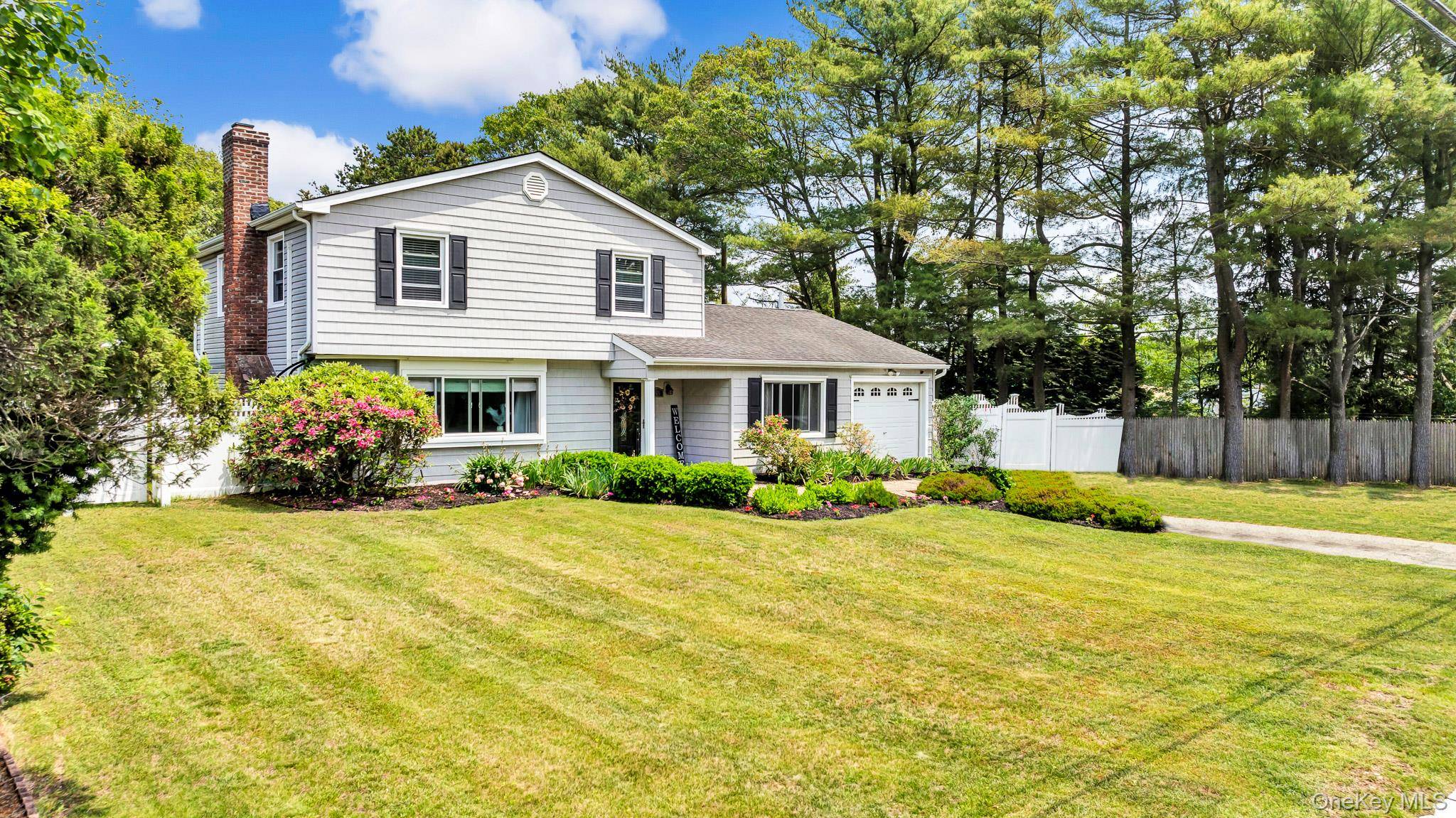 Nestled on a sprawling, elevated property in the desirable Tanglewood Hills section of Coram, Long Island, this classic colonial home offers both elegance and modern comfort.