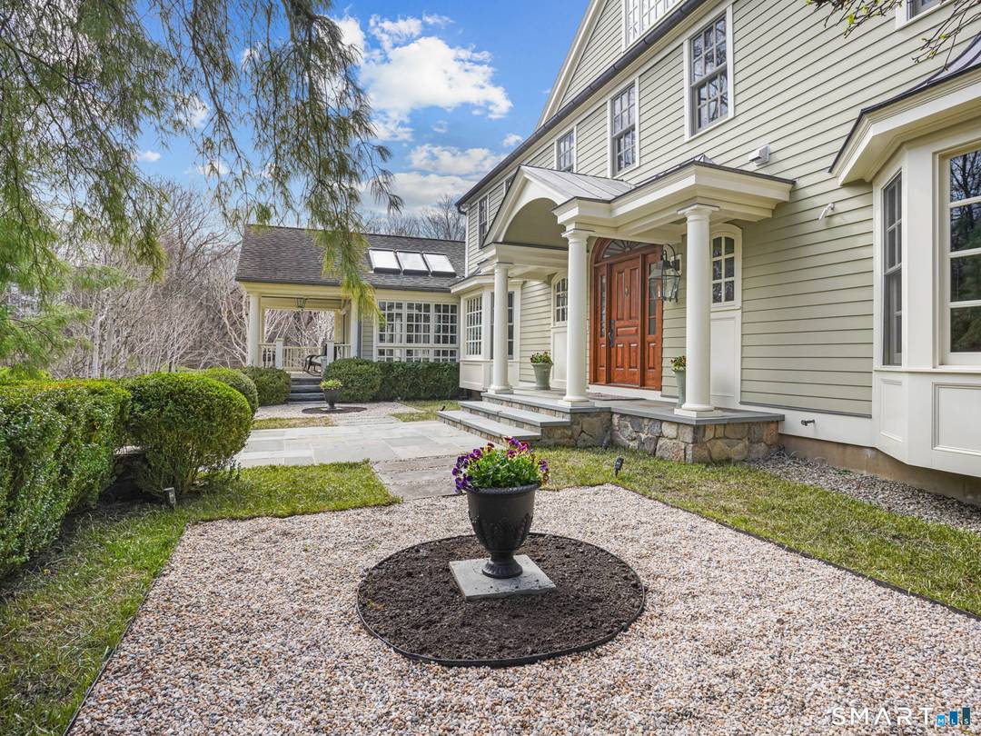 Designed by acclaimed architect Dinyar Wadia, this exceptional 5 bedroom estate is set on park like grounds just minutes from downtown New Canaan.