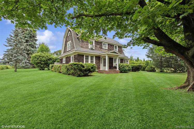 Bucolic farmhouse on three lush acres in the heart of Cutchogue !