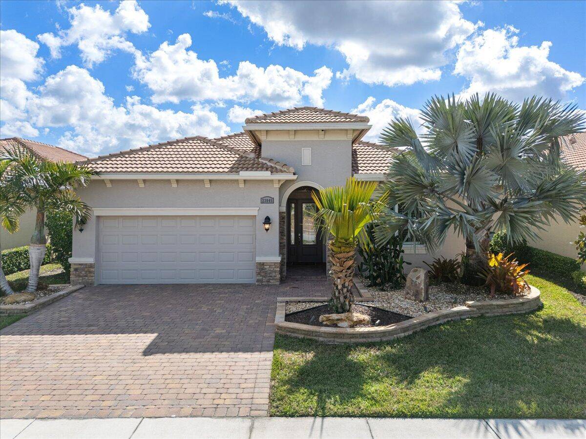 Beautiful ''Lago'' Model at Verano PGA Village with Great Curb Appeal exception tropical upgraded landscaping, solar landscape lighting, extended patio 468 sq ft WONDERFUL LAKE VIEW SETTING !