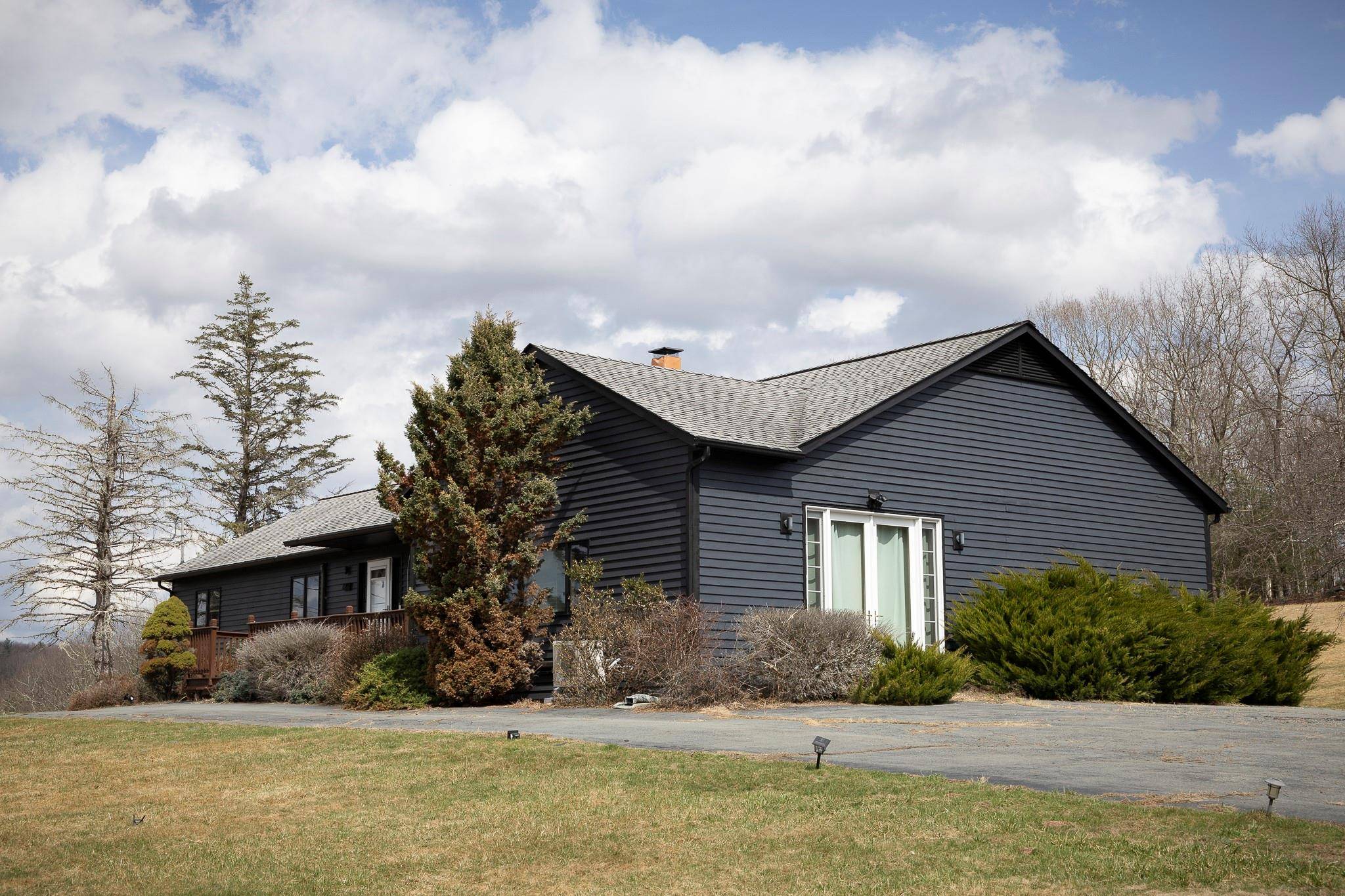 Welcome to this beautifully renovated four bedroom modern home on over six acres of scenic land, offering tranquility and stunning views of the surrounding hills and forest.