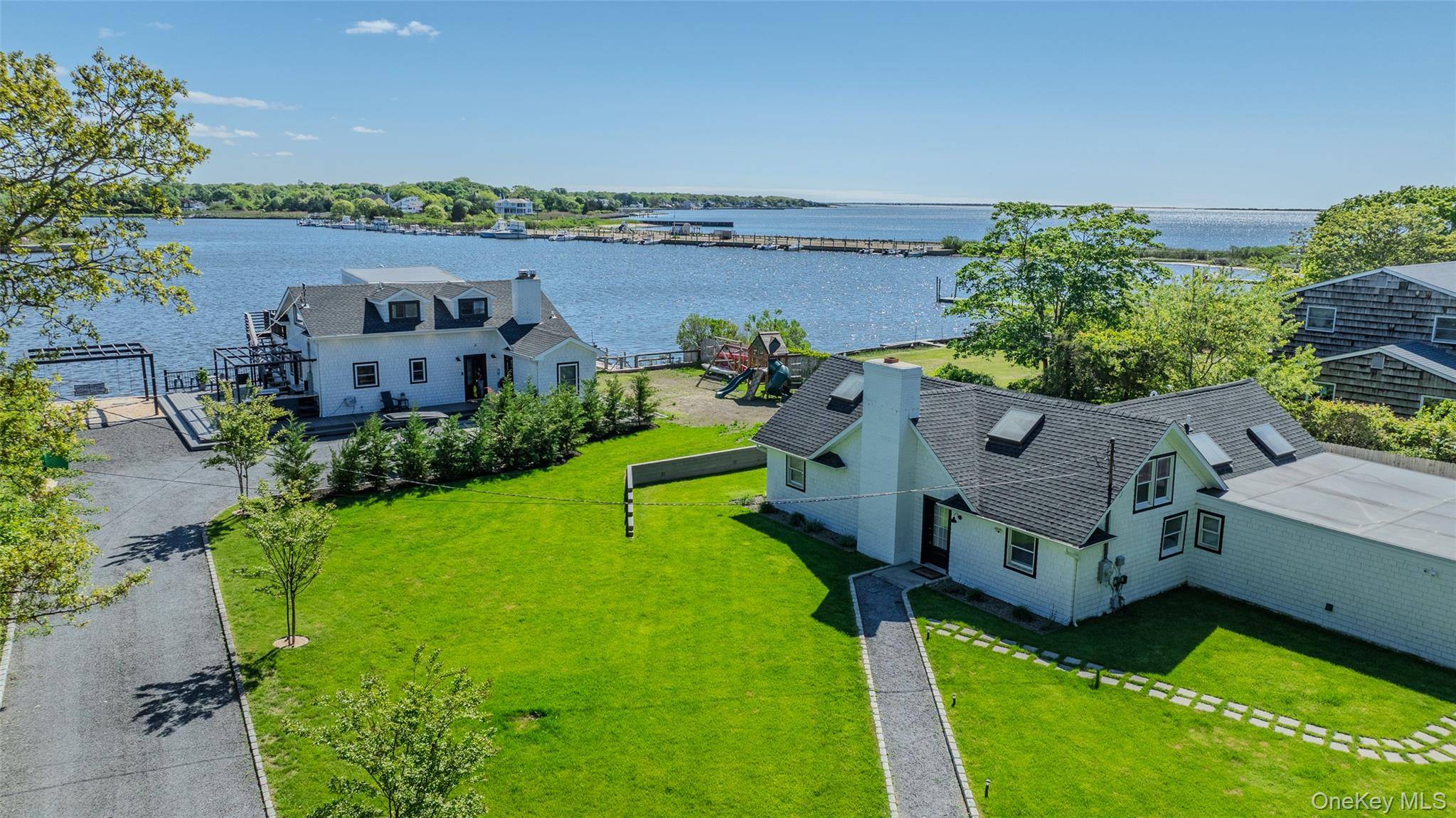 Experience the ultimate in coastal living with this extraordinary waterfront compound, privately nestled in the sought after Holiday Beach community.