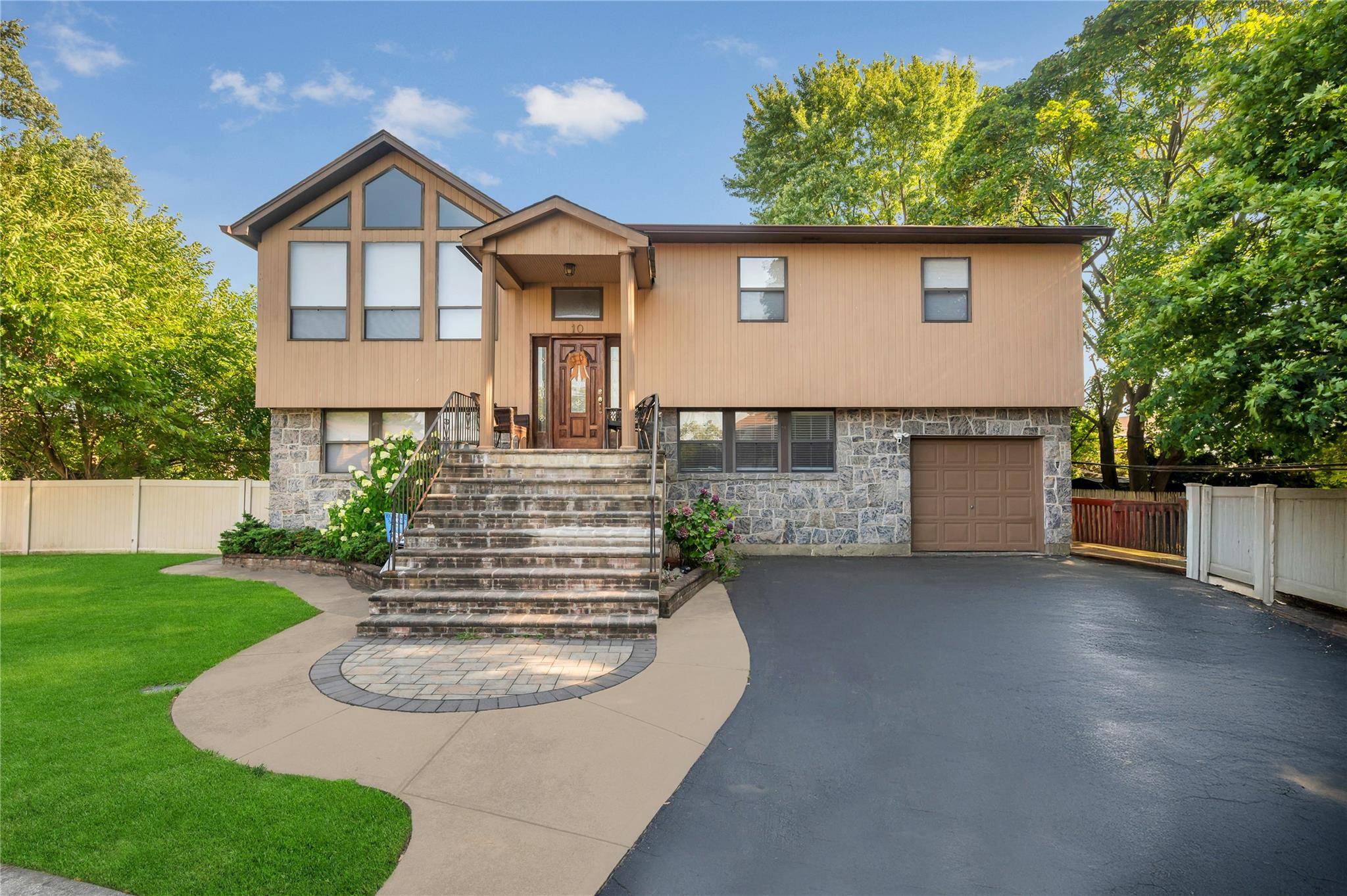 Welcome to this beautifully maintained Hi Ranch home nestled in a serene location in the heart of Hicksville.