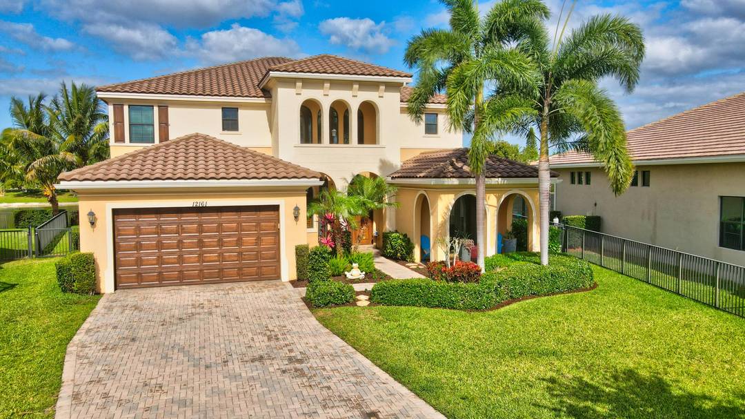 Stunning, spacious waterfront residence with a pool and spa, featuring breathtaking lake views from the second floor balcony, located in the prestigious gated community of Boca Reserve.