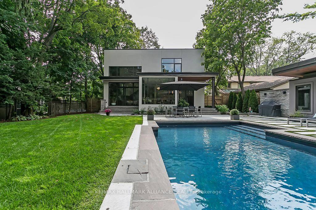 Welcome to this architecturally striking modern custom home, artfully crafted on a premium 0.