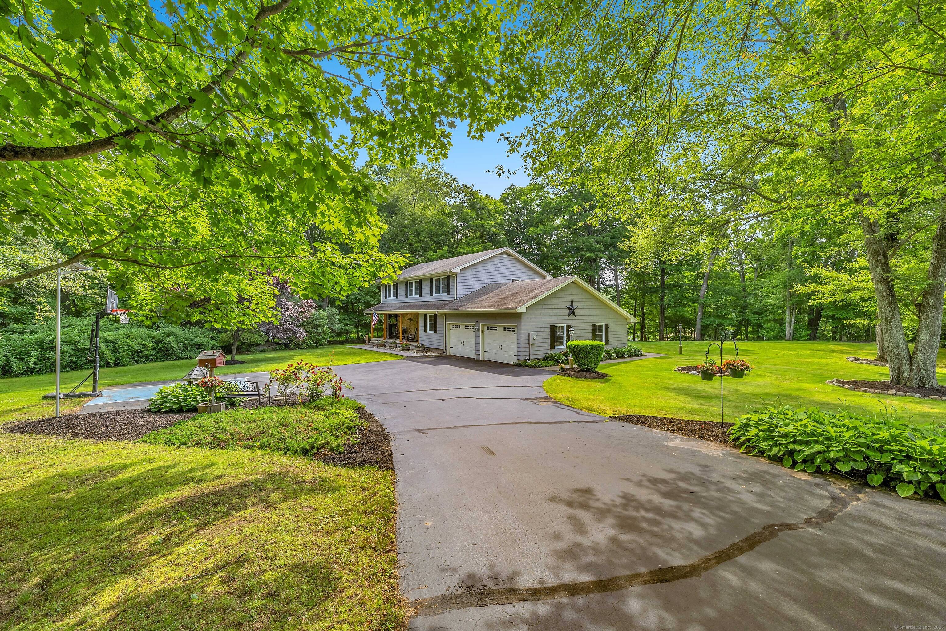 Welcome to 2 Naomi Lane where comfort, space, and New England charm come together on nearly an acre of private, level land in sought after East Lyme.