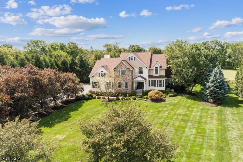 Set on almost 3 acres of manicured grounds in the premier Landmark at Long Valley, this stone accented Colonial is the embodiment of sophisticated country living.