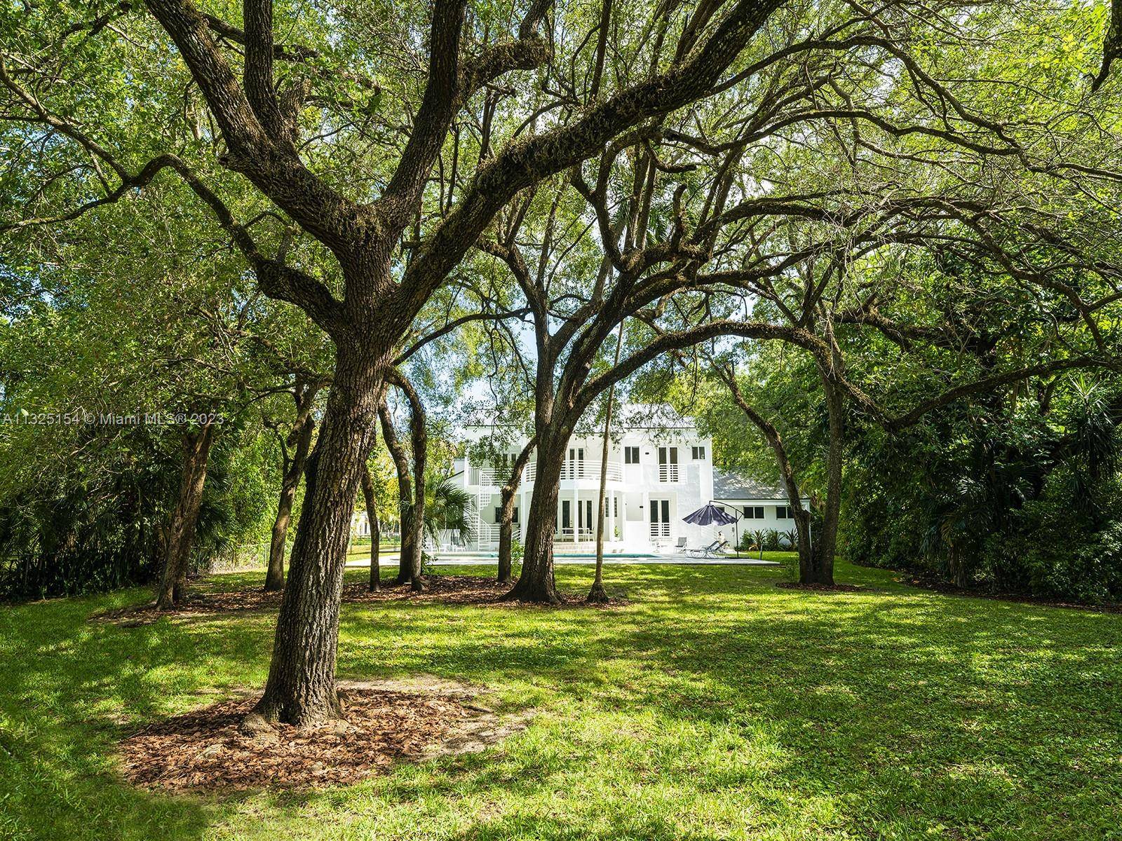 Experience absolute privacy and serenity from this one acre two Story hidden gem, tucked away on a 300ft private driveway in North Pinecrest.