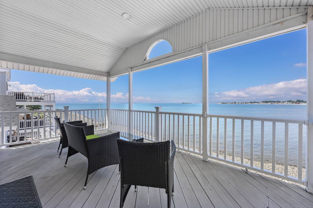 Enjoy the best of coastal living in this fully furnished direct waterfront home in Milford's Point Beach community.