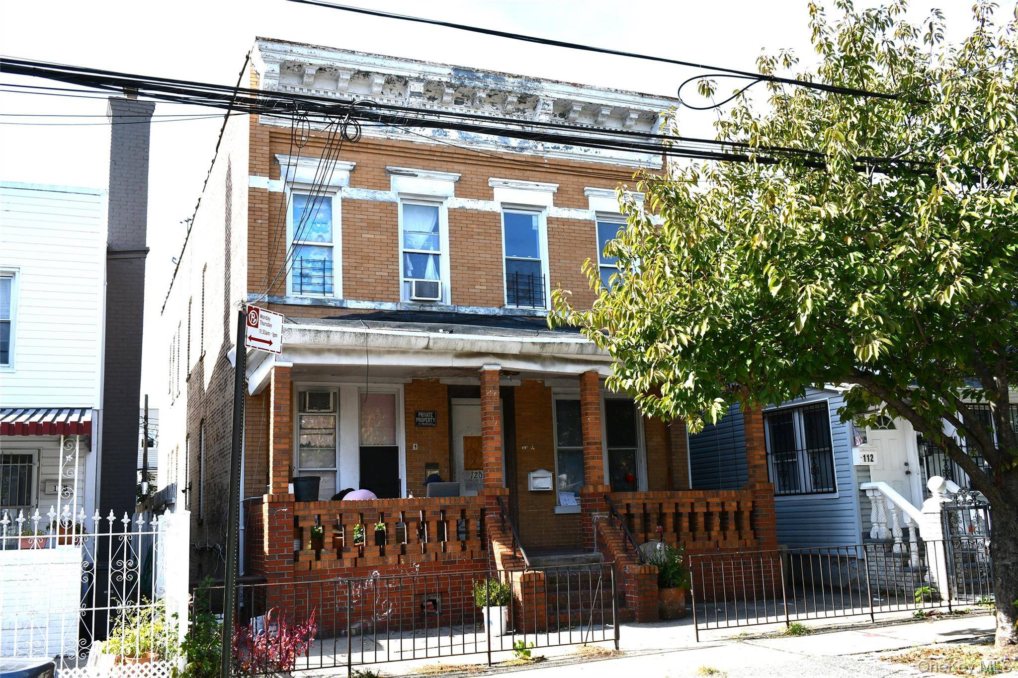 4 Family Brick detached Colonial with 12 bedrooms and 4 full baths.