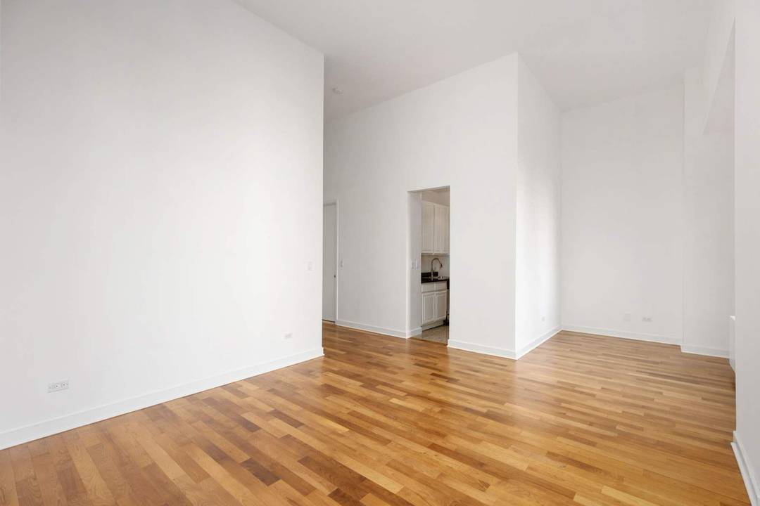 Step into this dramatic, loft like studio where soaring 13 foot ceilings and oversized windows fill the living and sleeping space with abundant natural light.