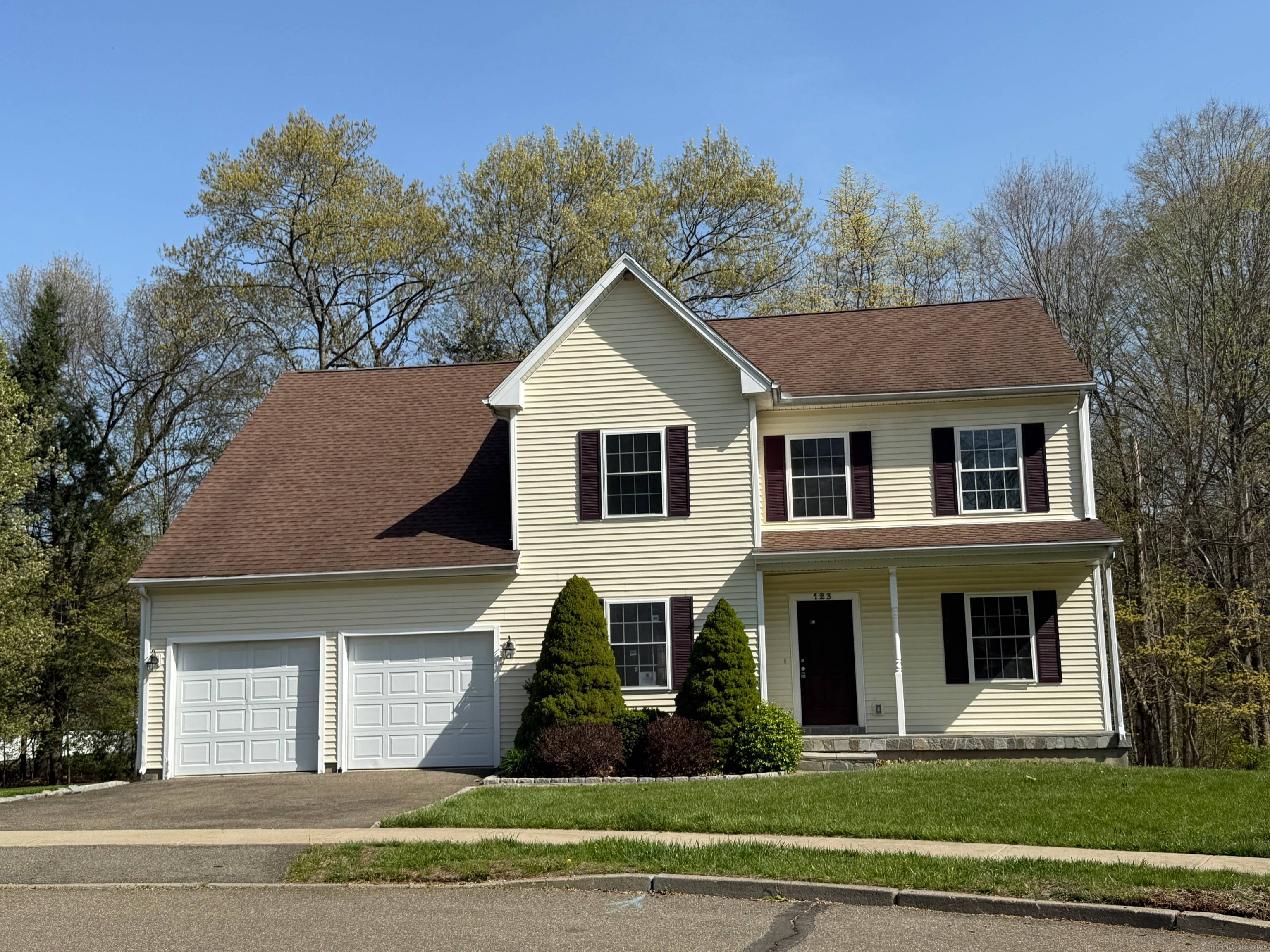 Vinyl sided Colonial with attached 2 car garage.
