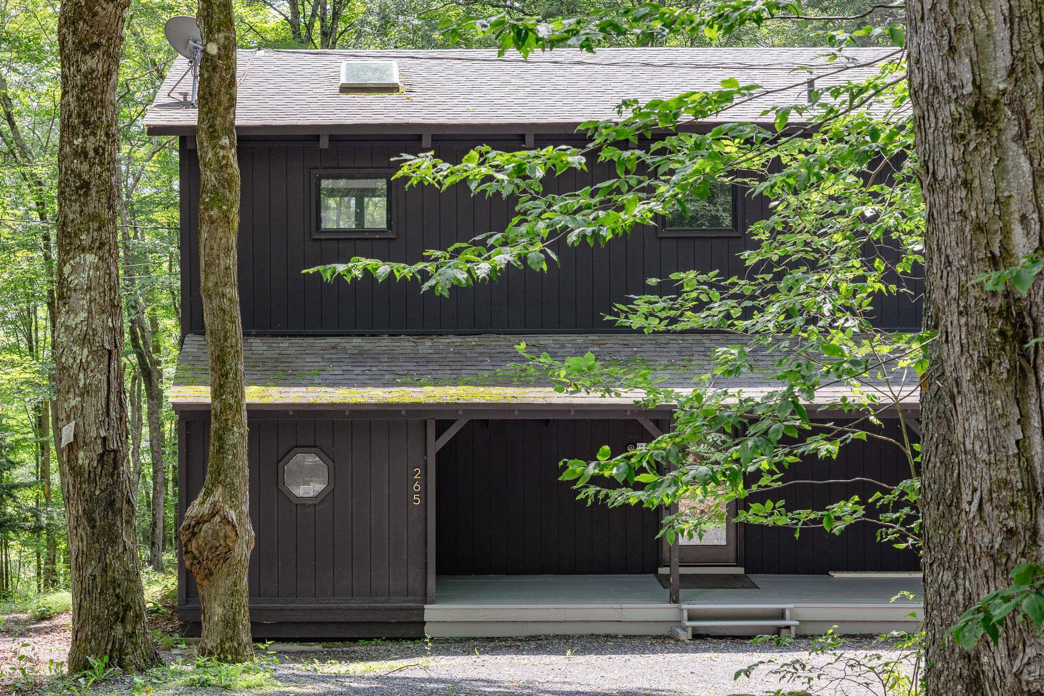 Tucked into the trees and hidden from the world, this contemporary home in Pine Hill, NY feels less like a house and more like a very tasteful treehouse equal parts ...