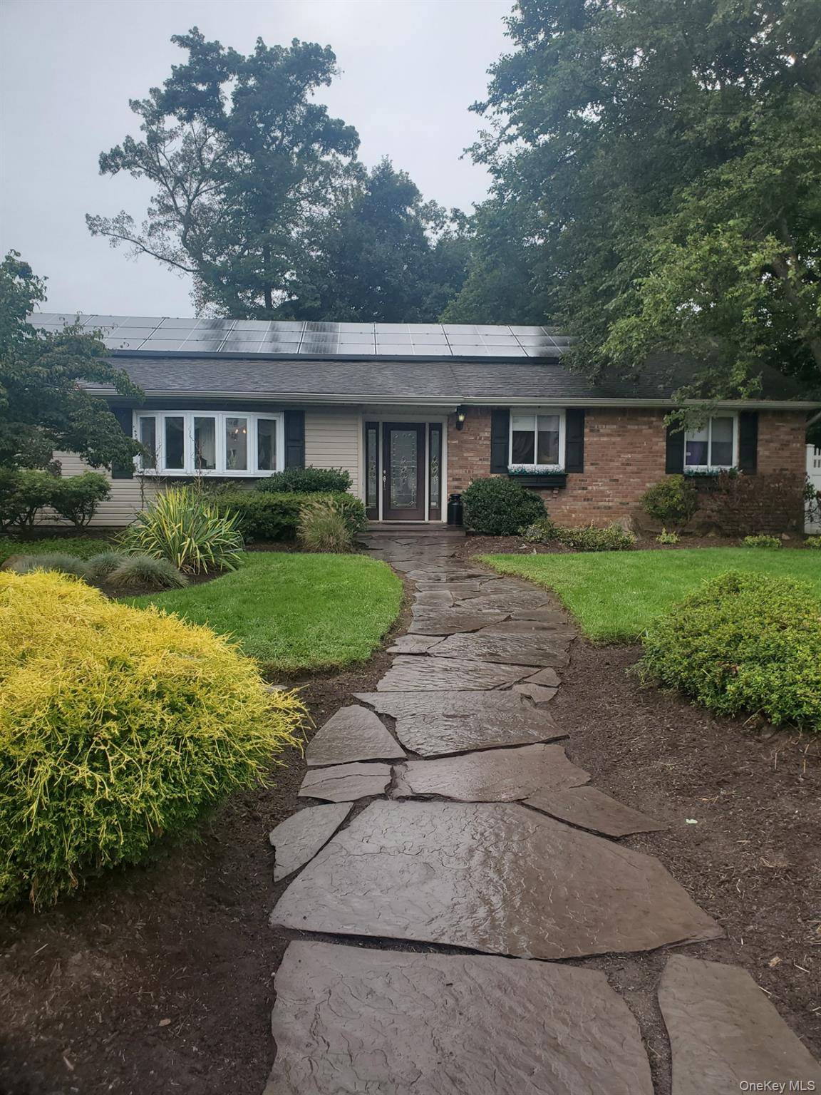 professionally landscaped front yard, oversized lot, new kitchen opens to den with wood burning fireplace, partially finished basement with outside entry, oversized driveway offers ample off street parking