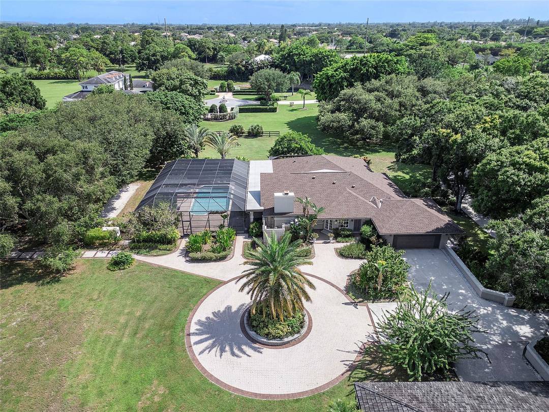 Nestled on over 5 lush acres, this private estate offers luxury and tranquility behind a double gated entrance.