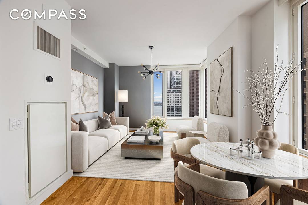 Perched on a high floor at 15 William Street, this two bedroom, two bathroom residence combines luxury finishes with sweeping views of the East River and downtown skyline.