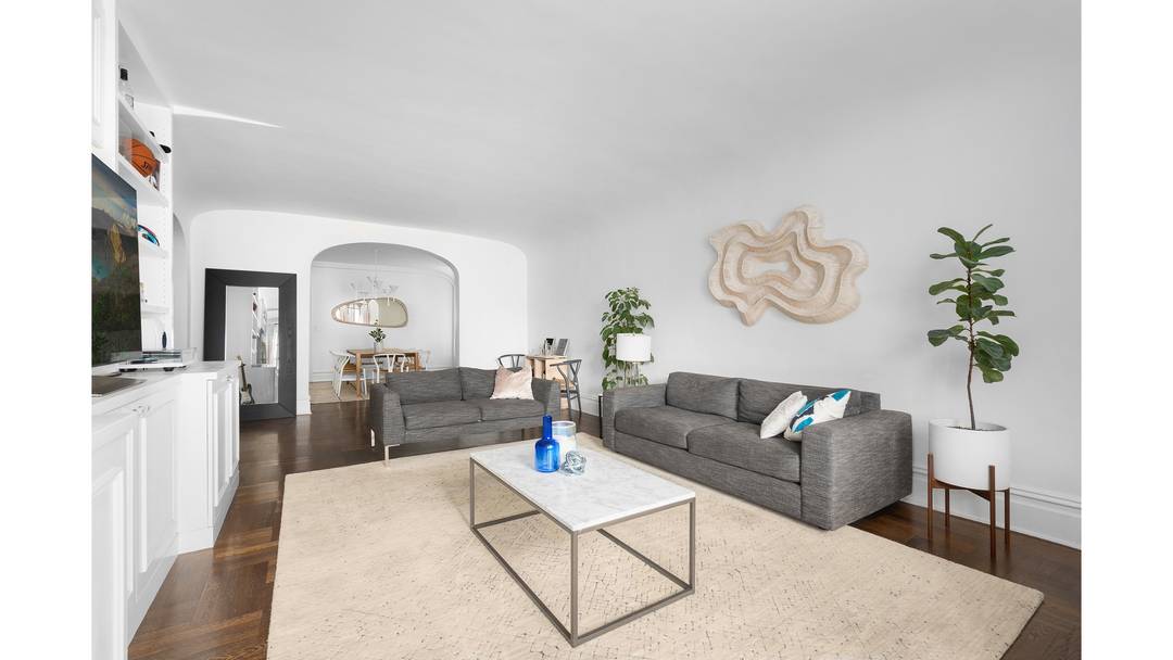 A gracious, oversized foyer welcomes you in, framed by iconic arched doorways that set the tone for the home's classic pre war charm.