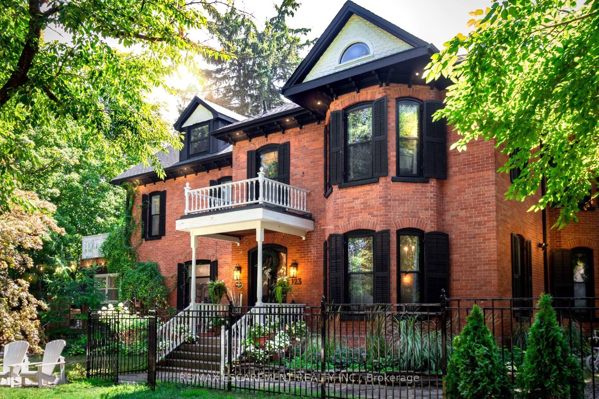 The Dolmage House, a historic Grimsby landmark surrounded by mature trees amp ; nature.