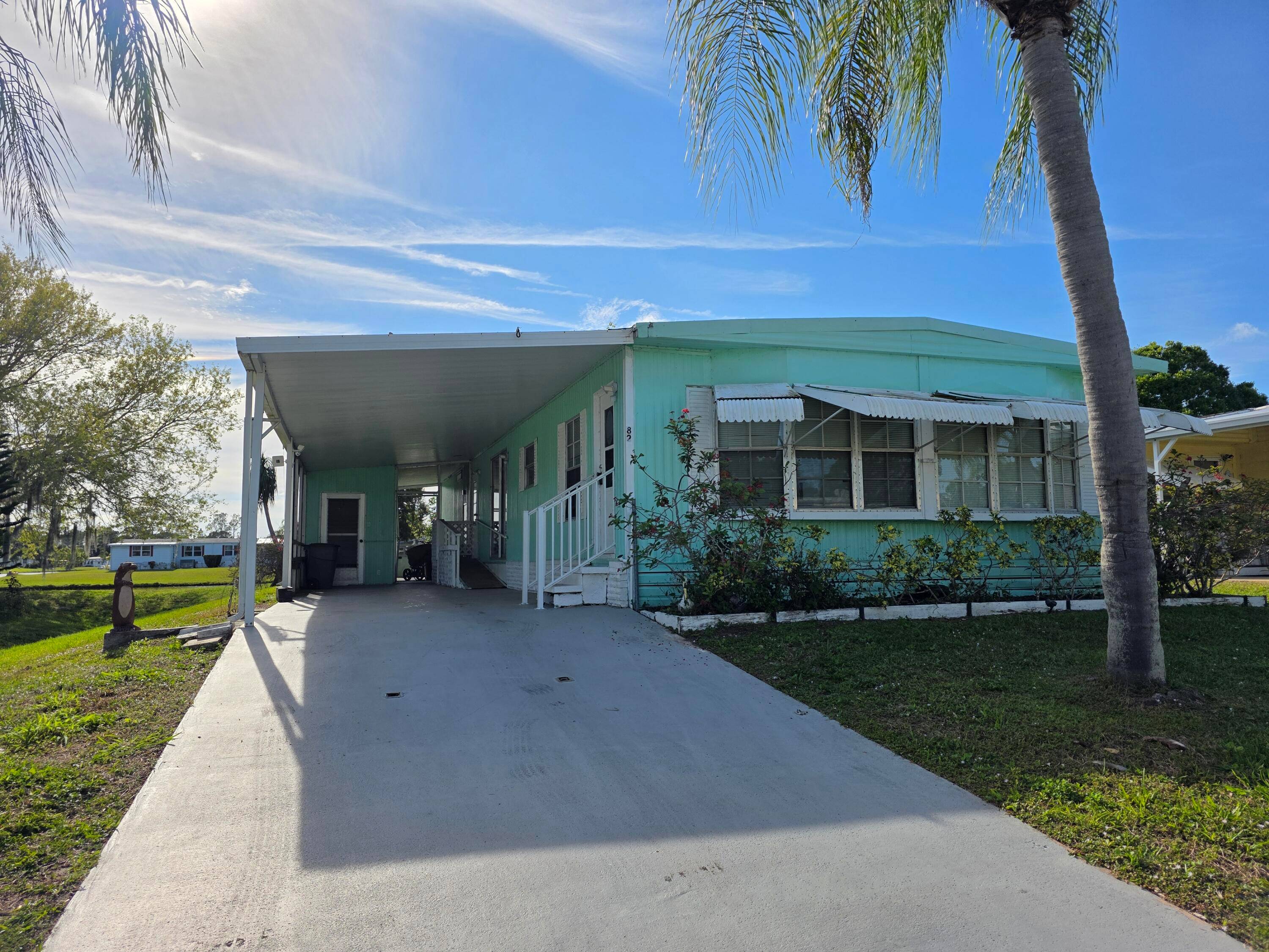One month of free lot rent for this lakeside handyman's retreat in the vibrant 55 community of Spanish Lakes Golf Village.