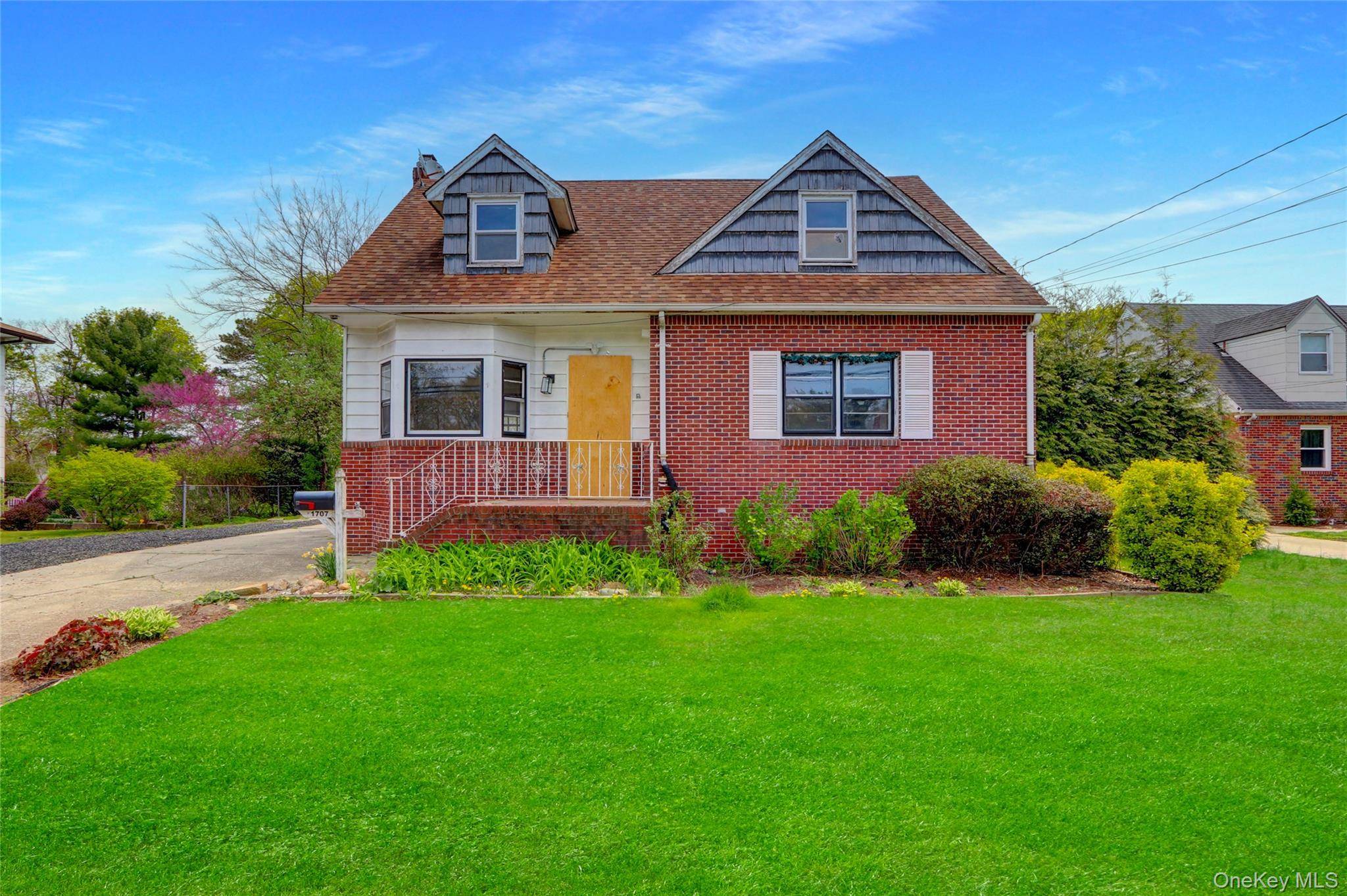 Large cape cod style home with full basement, having a great backyard, spacious bedrooms, and exceptional potential.