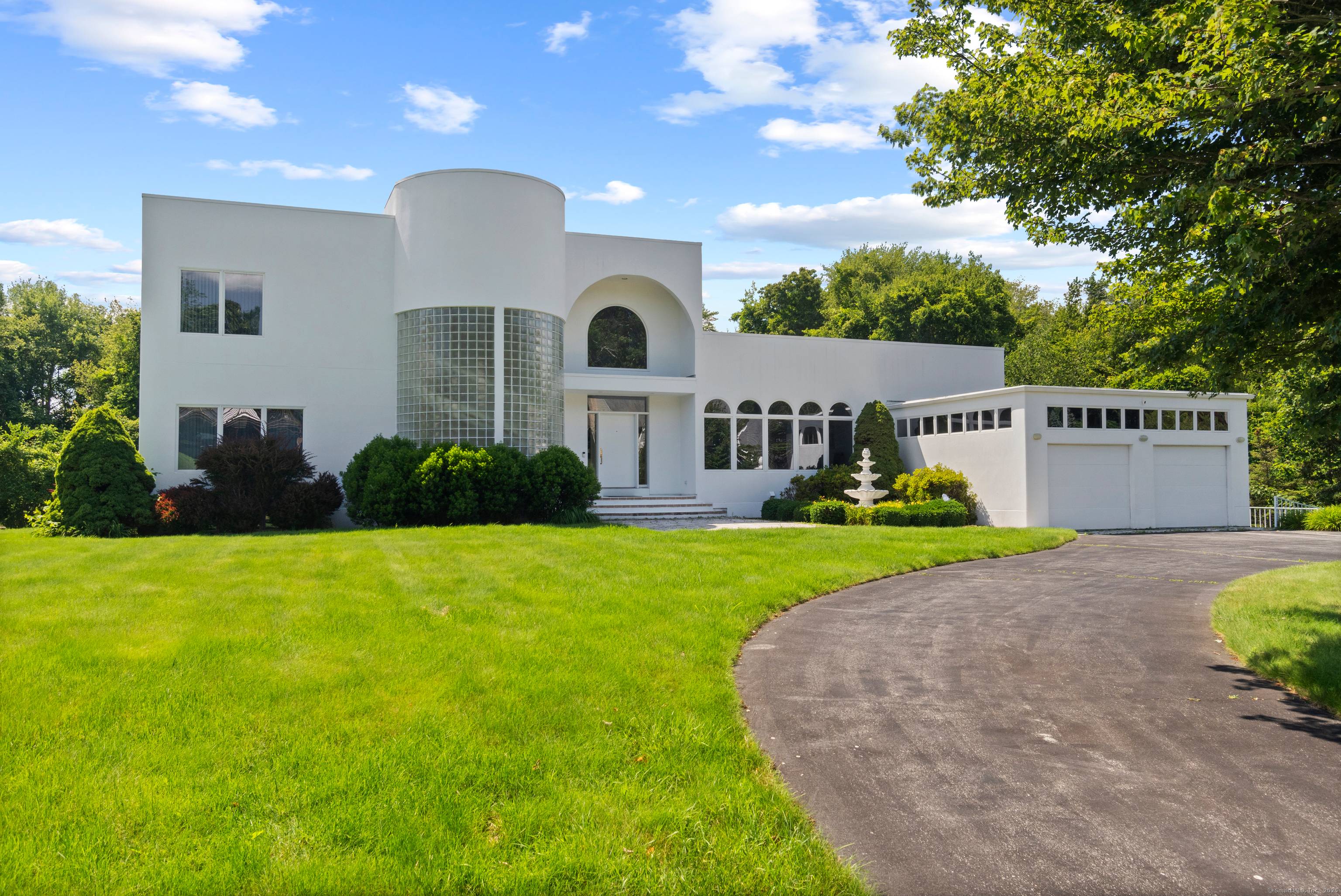 This elegant contemporary home in Noank, CT, offers a seamless blend of luxury and modern design, featuring soaring high ceilings and an expansive open floor plan that creates a sense ...