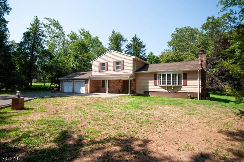 Custom built split level with very large rooms and private lot set back from street.