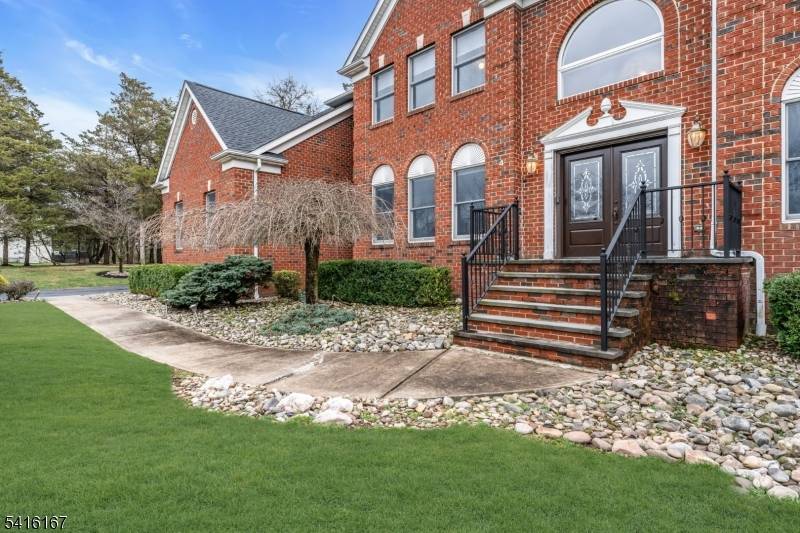 Nestled on a quiet cul de sac this exceptional home sits on a beautifully level 1 acre property, offering privacy, space, timeless elegance.