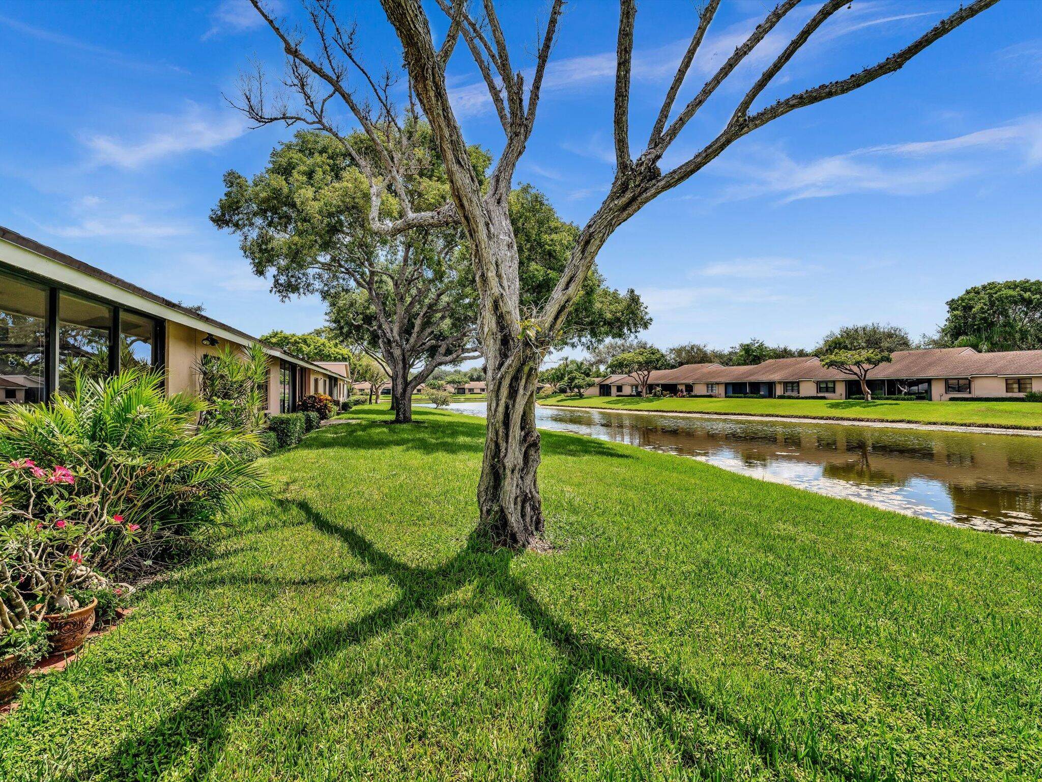 Well priced private Villa w a view, Lg 2 2, split bedrooms, plus glass enclosed patio facing lake w 1 car garage but 2 extra parking spaces.