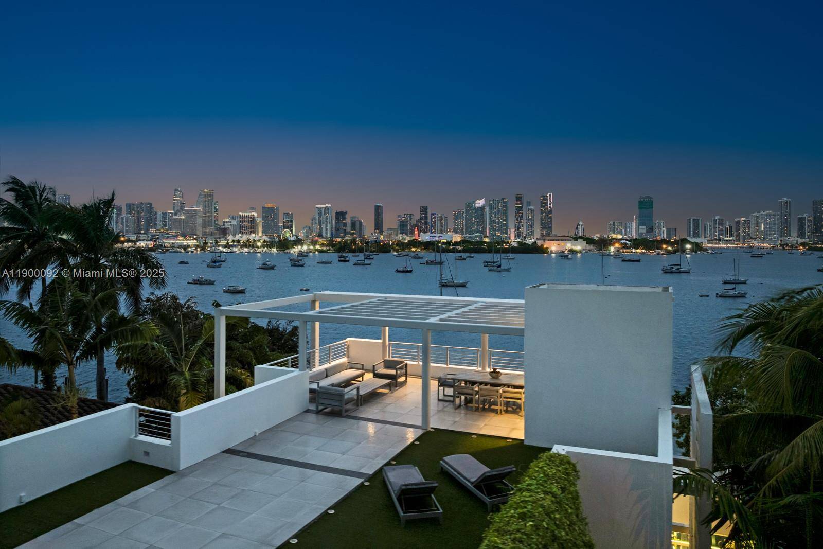 This sleek ultra modern tri level waterfront masterpiece is perfectly situated on the coveted tip of Hibiscus Island, offering breathtaking, unobstructed views of the bay, yachts, and the Miami skyline.