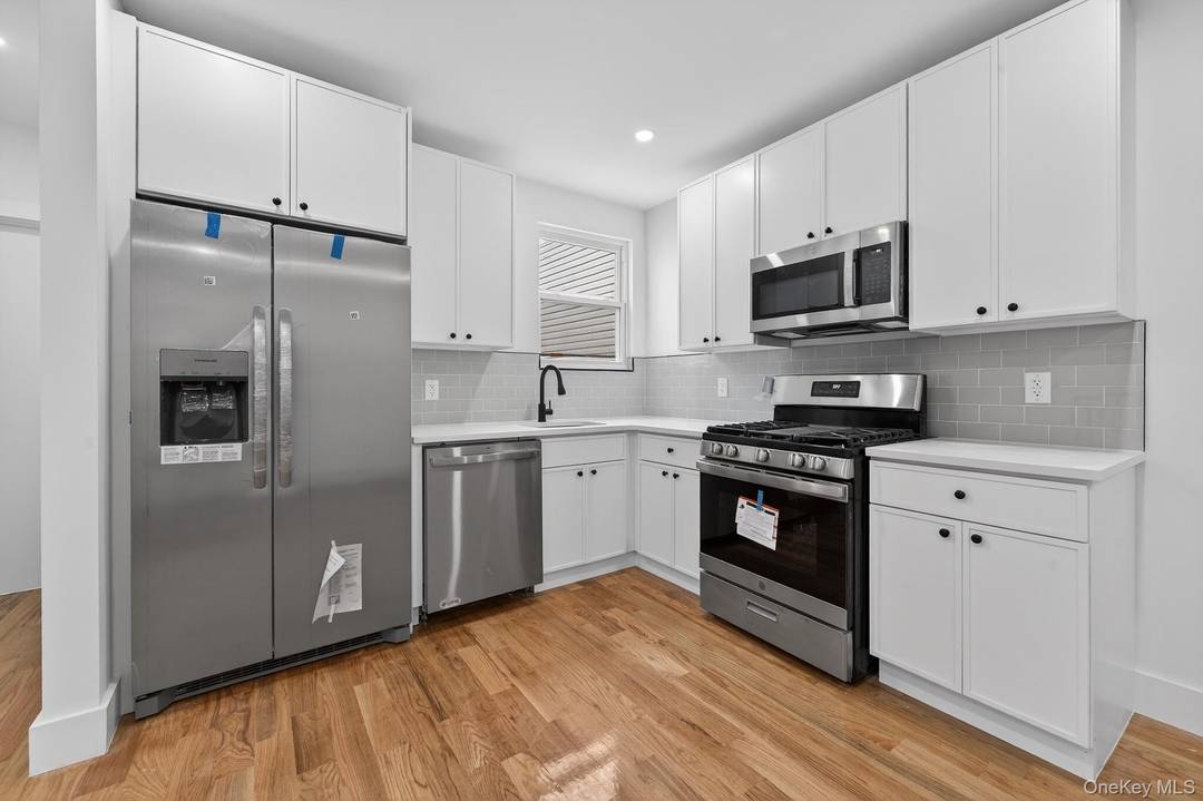 25 61 99th Street is a turn key, move in ready two family nestled on a beautiful tree lined street of East Elmhurst.