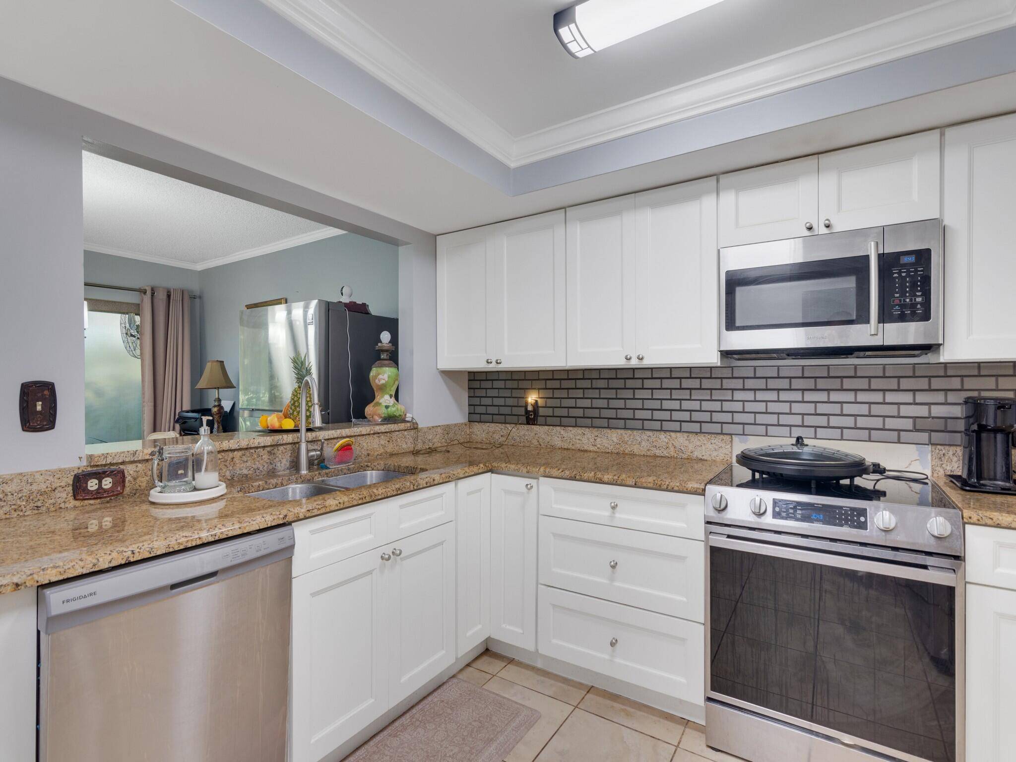 Discover your ideal retreat in this rare 2 bed, 2 bath first floor corner unit with a stunning wrap around screened patio.