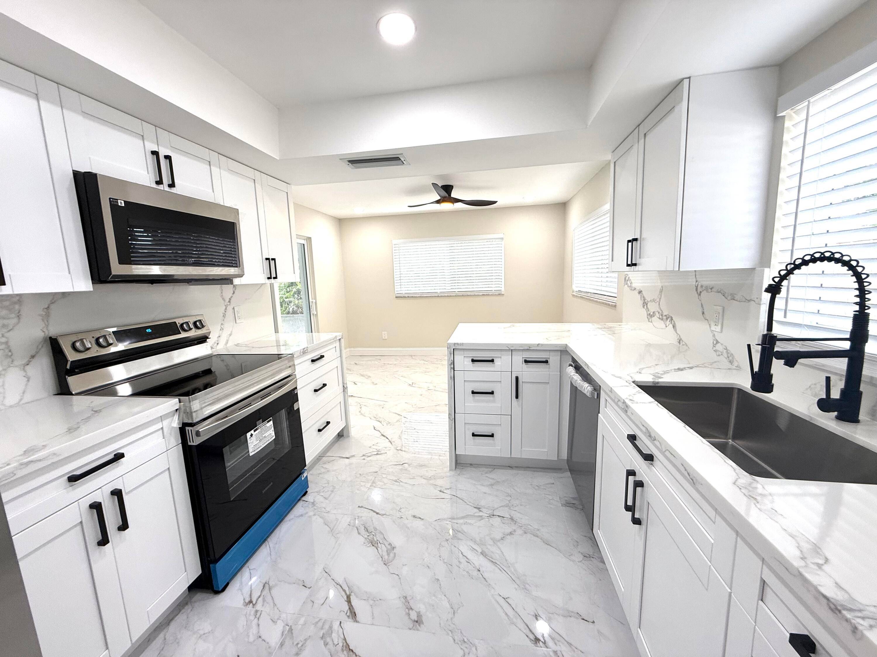Completely renovated 3 bedroom, 2 bath modern home featuring numerous upgrades, including a new A C, impact windows and doors throughout, stylish new light fixtures, premium porcelain tile and waterproof ...