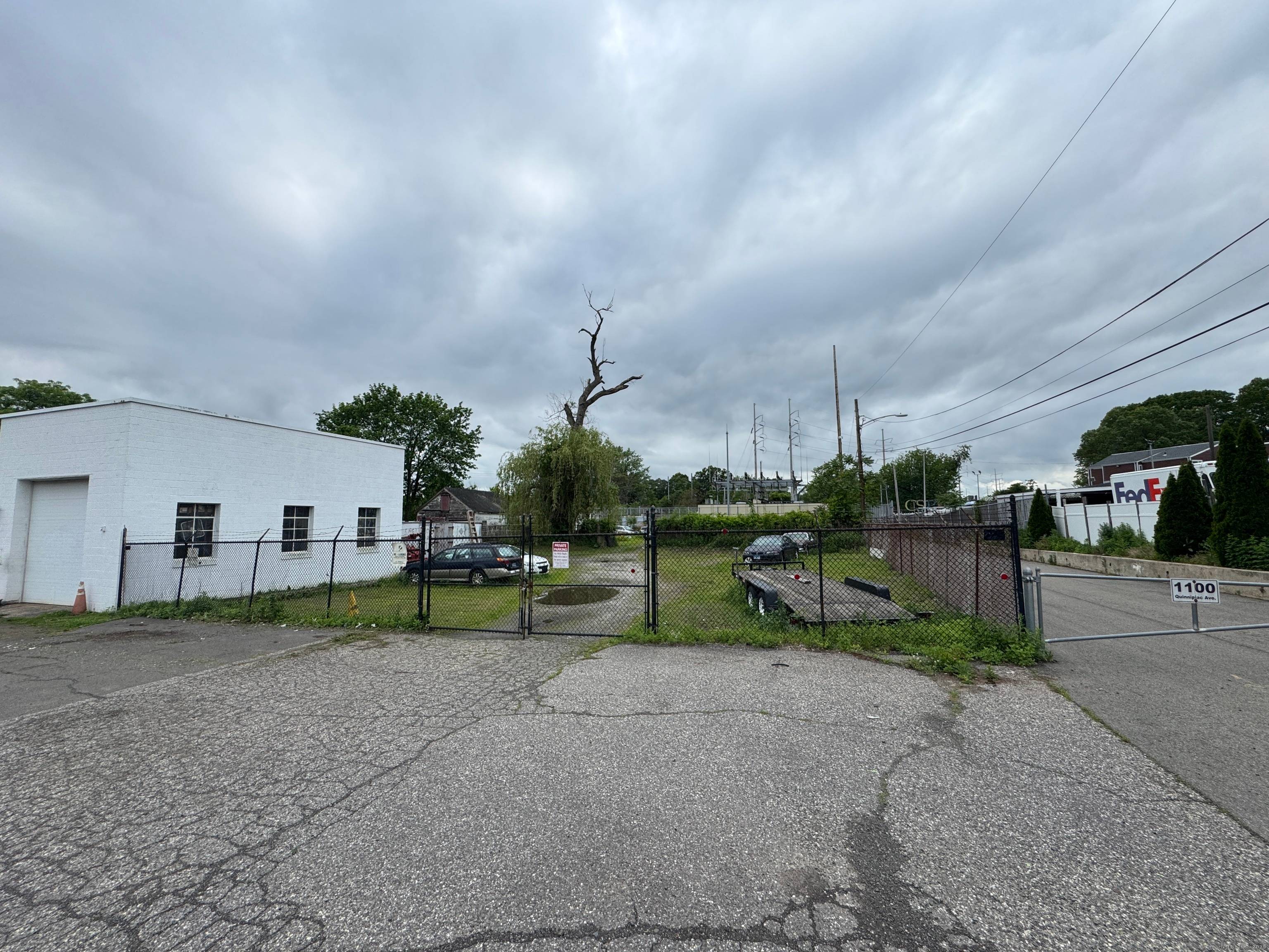 This property, formerly a gas station, is currently being utilized as an auto repair shop and used car dealership.