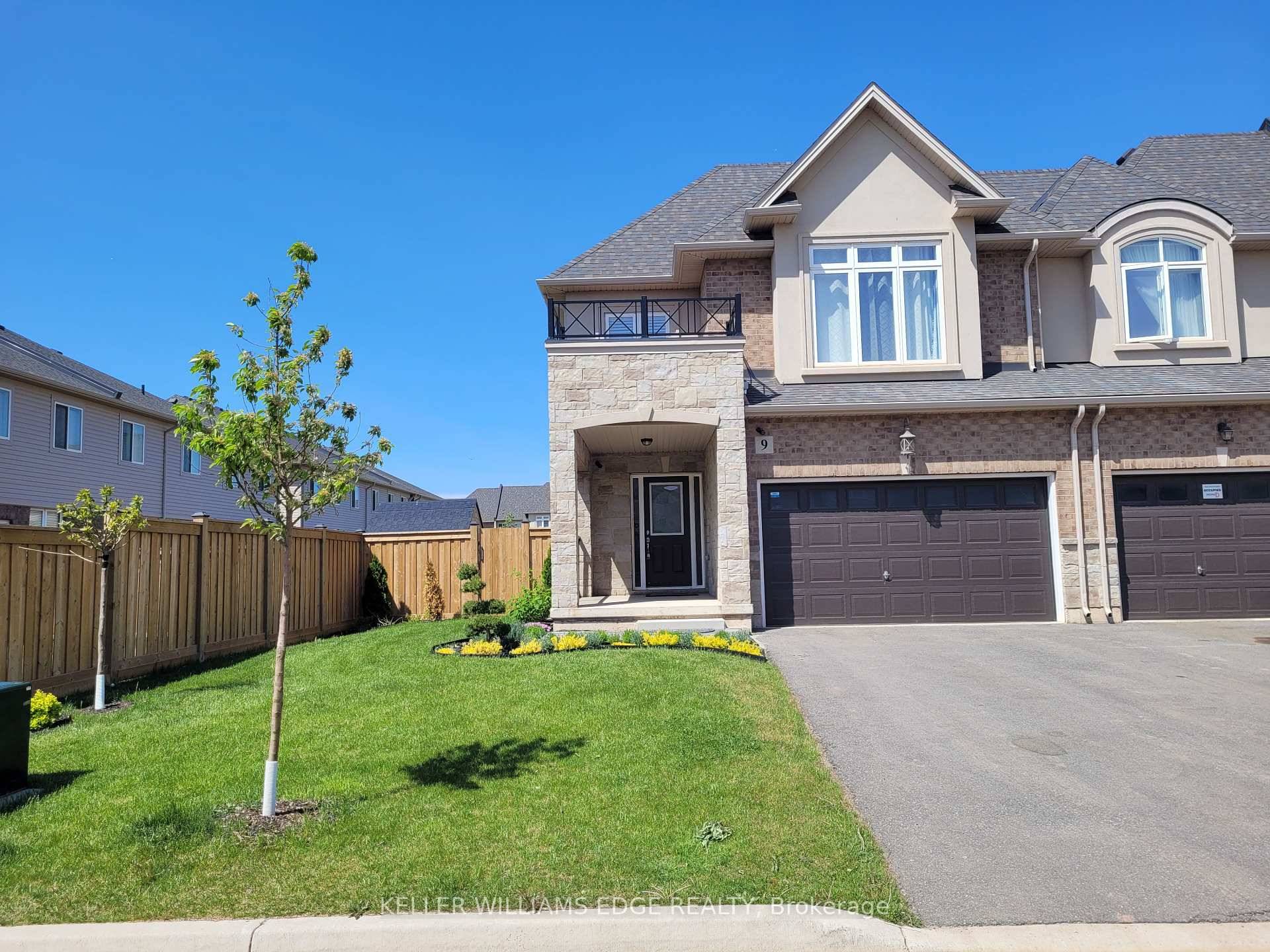 Elegant 2 storey end unit townhome on a premium lot in the prestigious Foothills of Winona !