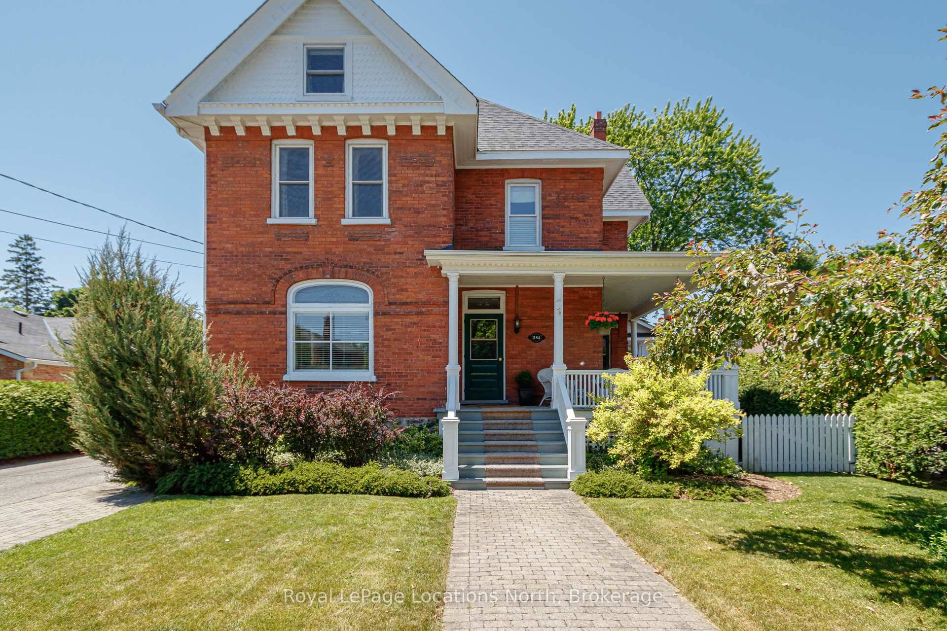 Step inside this stately red brick century home, where timeless charm meets thoughtful updates.