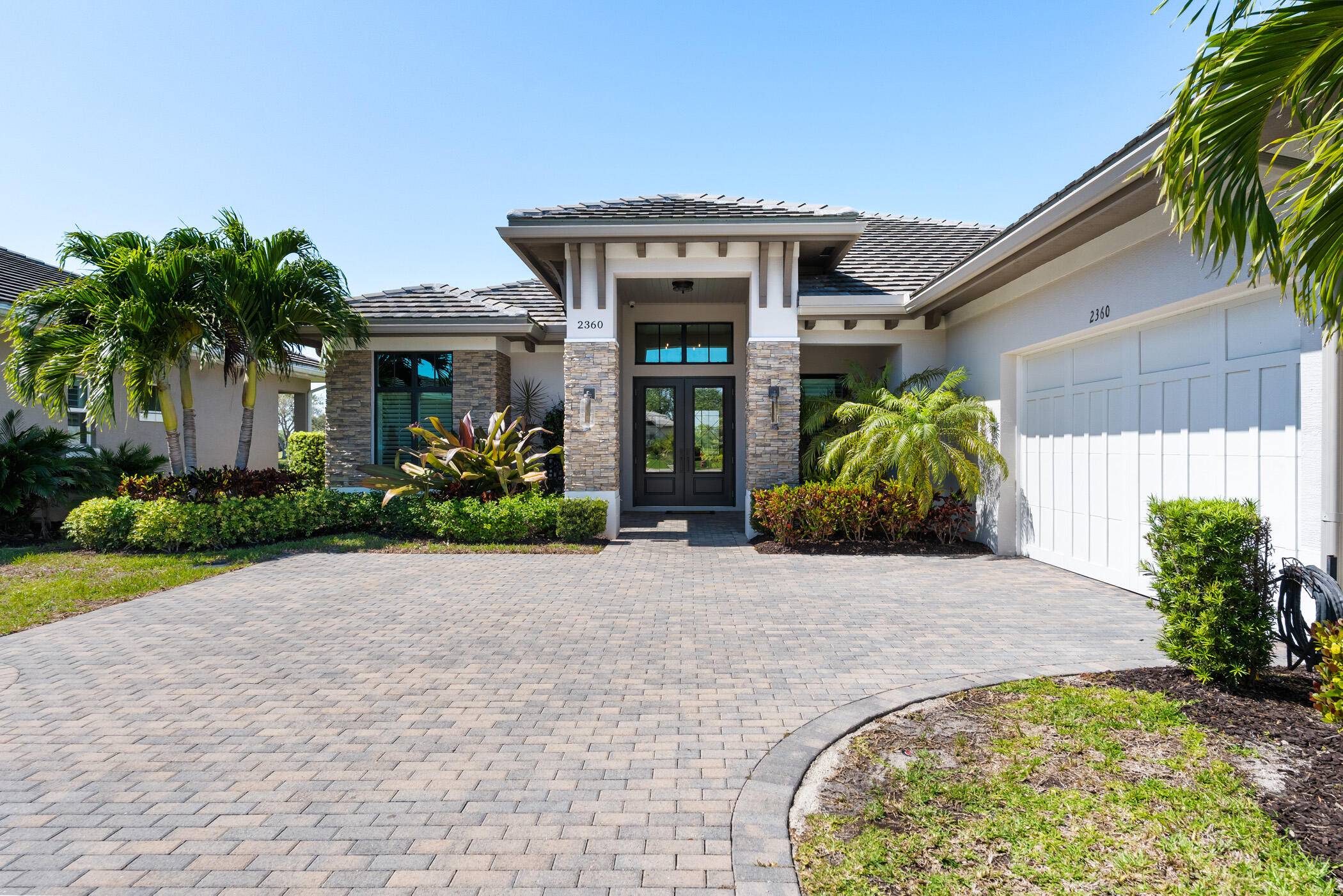 Enjoy sensational sunsets over the water from this spectacular home in the Reserve at Grand Harbor.