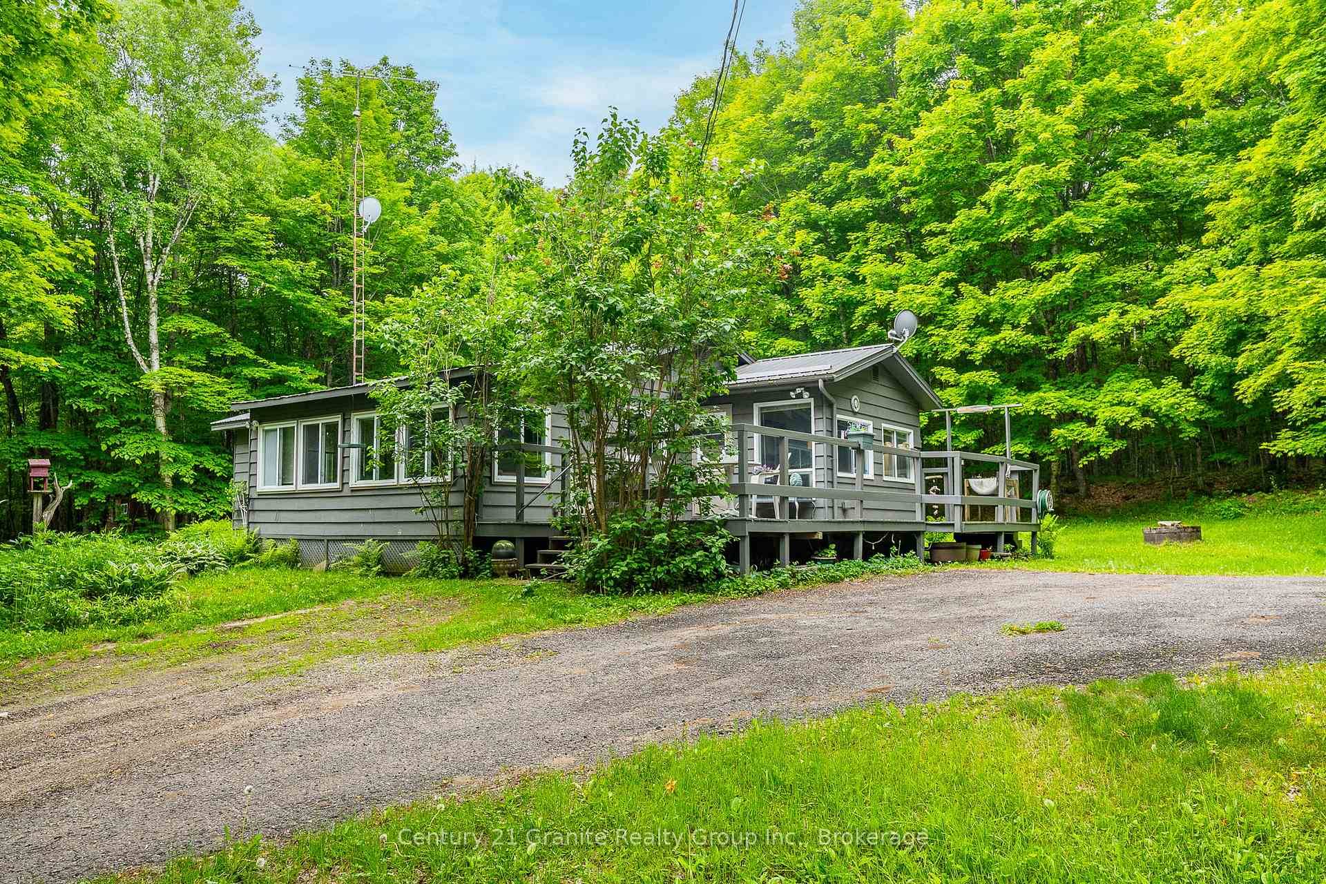 Tucked among mature trees and lush perennial gardens, 1553 Kushog Lake Road offers a unique opportunity for those seeking privacy, versatility, and a true cottage country experience.